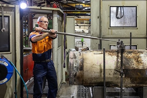 a man fixing a hydraulic equipment