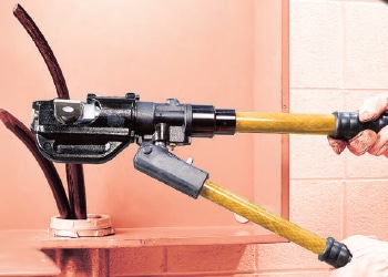 a man using a specialised force cable handling to cut a cable