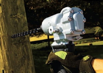 a man using a specialised force hydraulic tool on wood